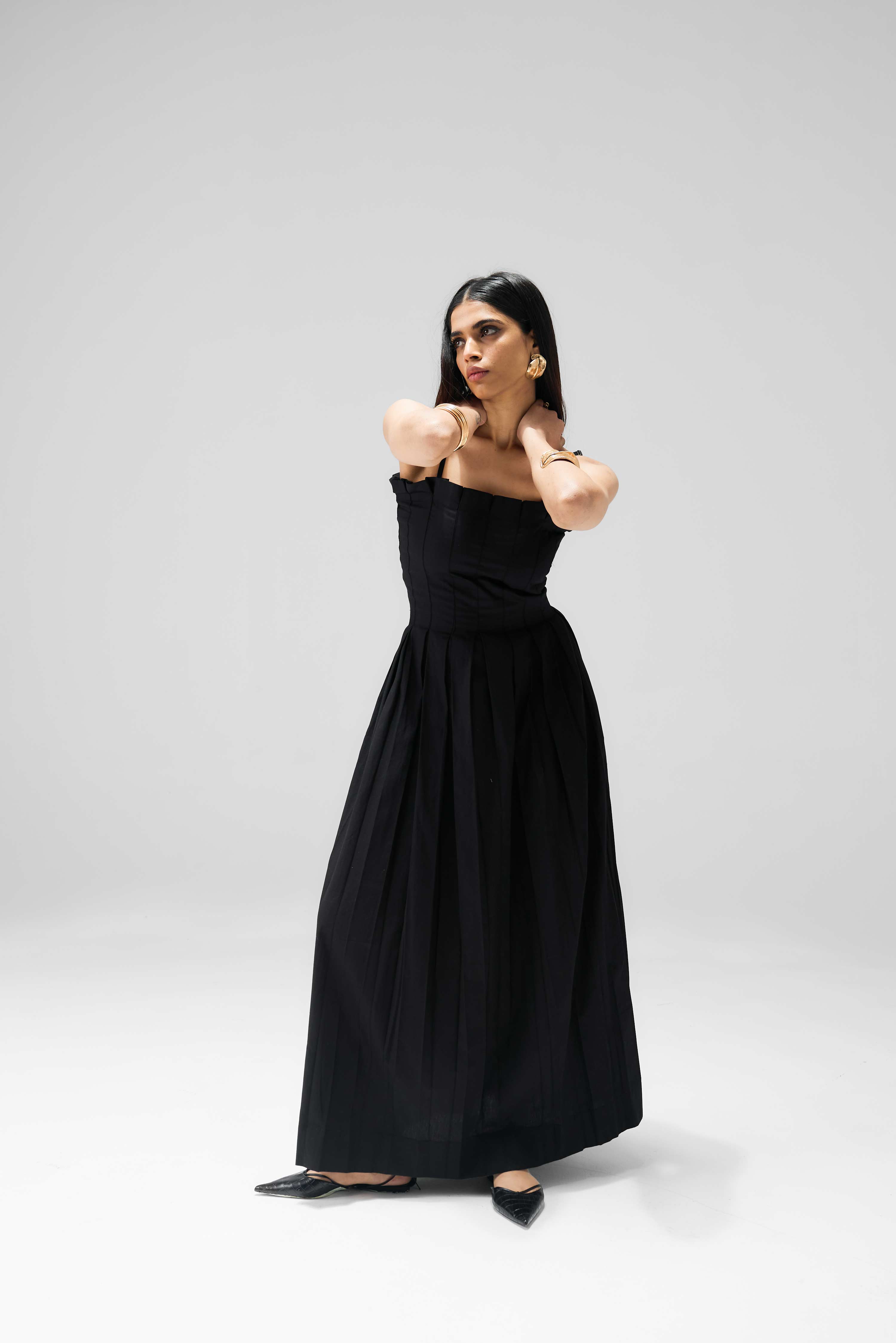 Full-length pleated dress with structured bodice and pleats