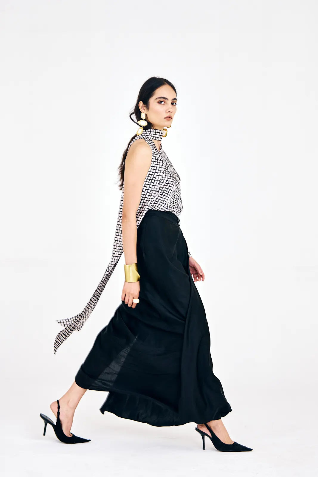 Model wearing XS striped one-shoulder top and black skirt set