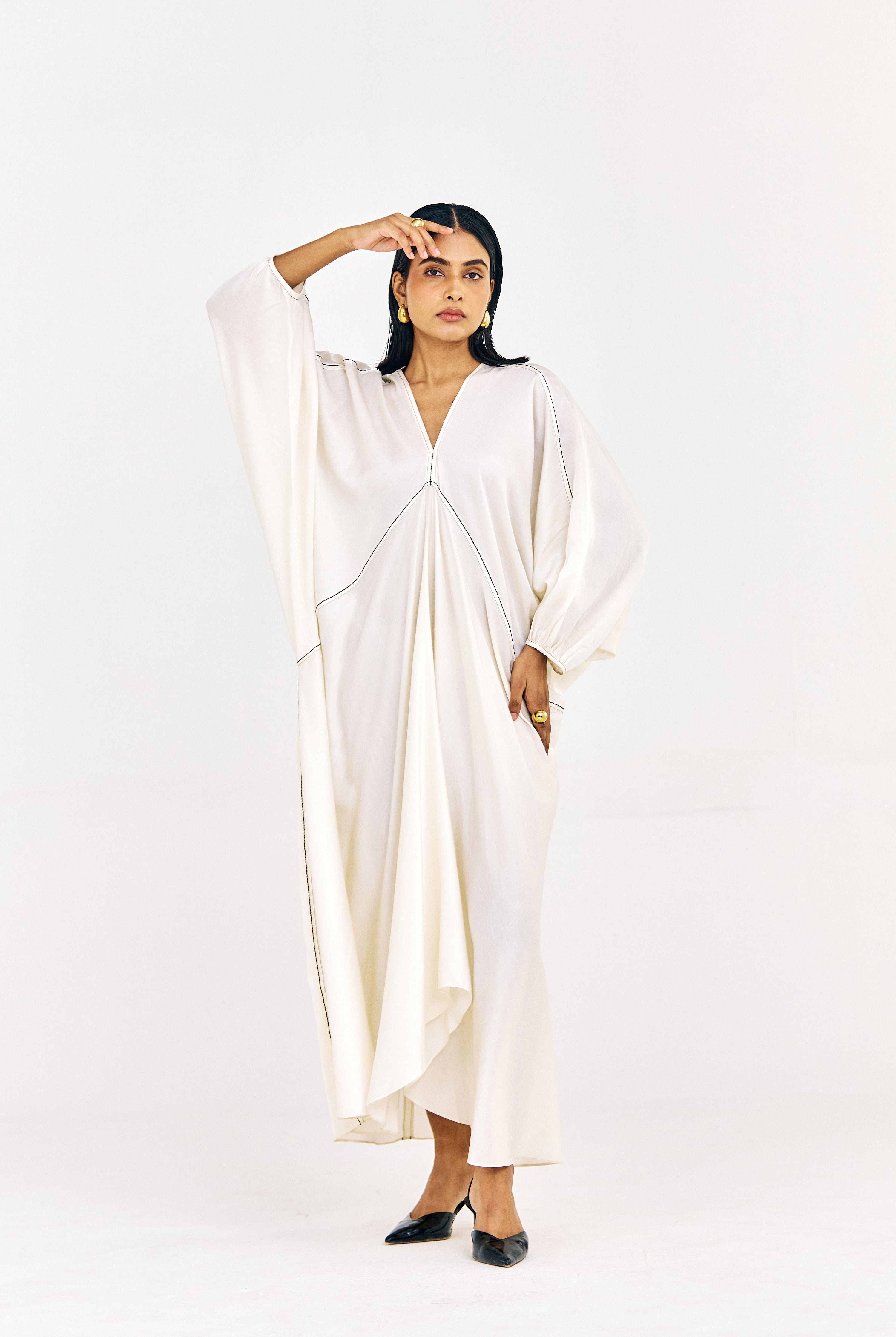 Front view of long striped kaftan-style top with soft movement