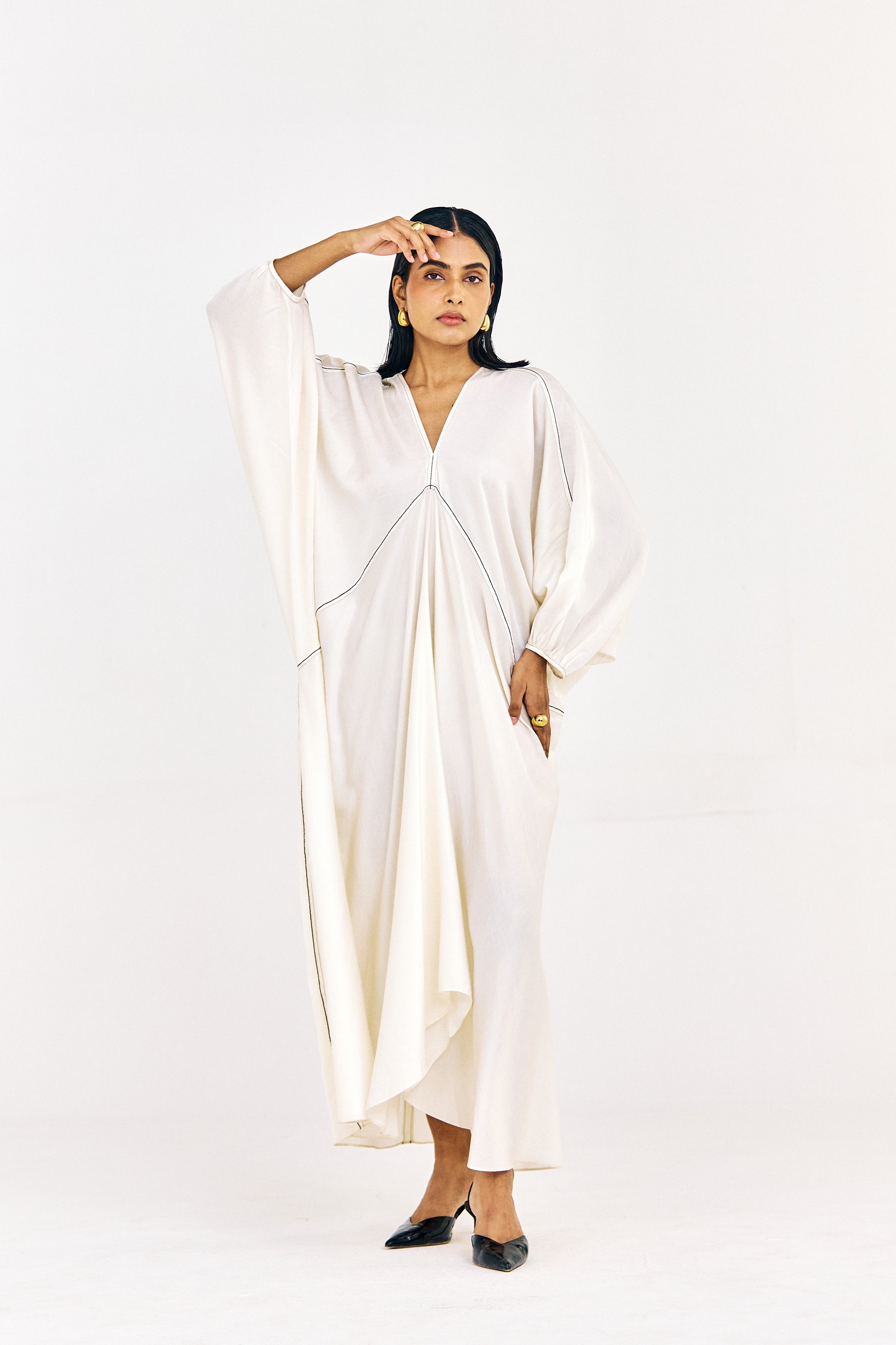 Front view of long striped kaftan-style top with soft movement