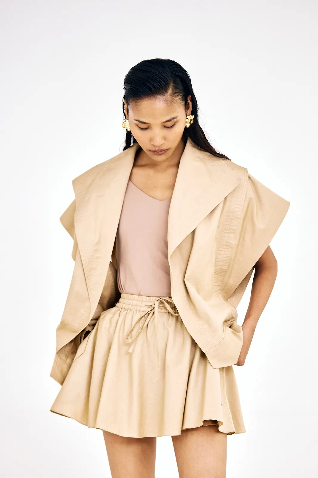Women’s beige co-ord set featuring a short jacket and relaxed-fit skirt
