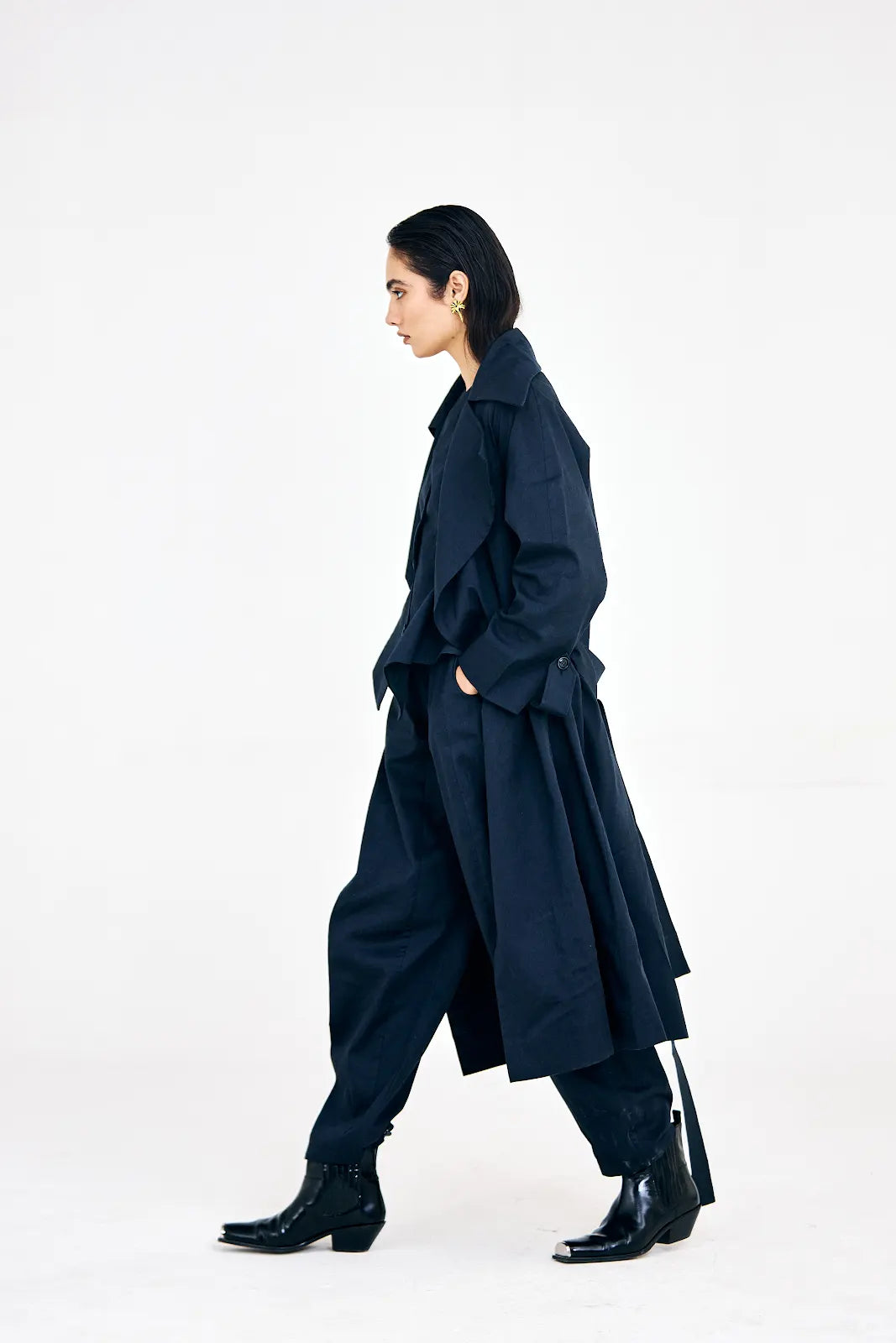 Button-down waistcoat paired with barrel pants and tailored trench coat