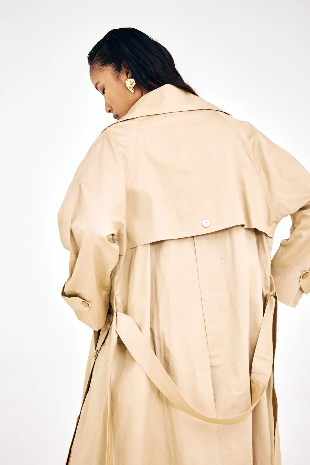 Button-down waistcoat paired with barrel pants and classic trench coat