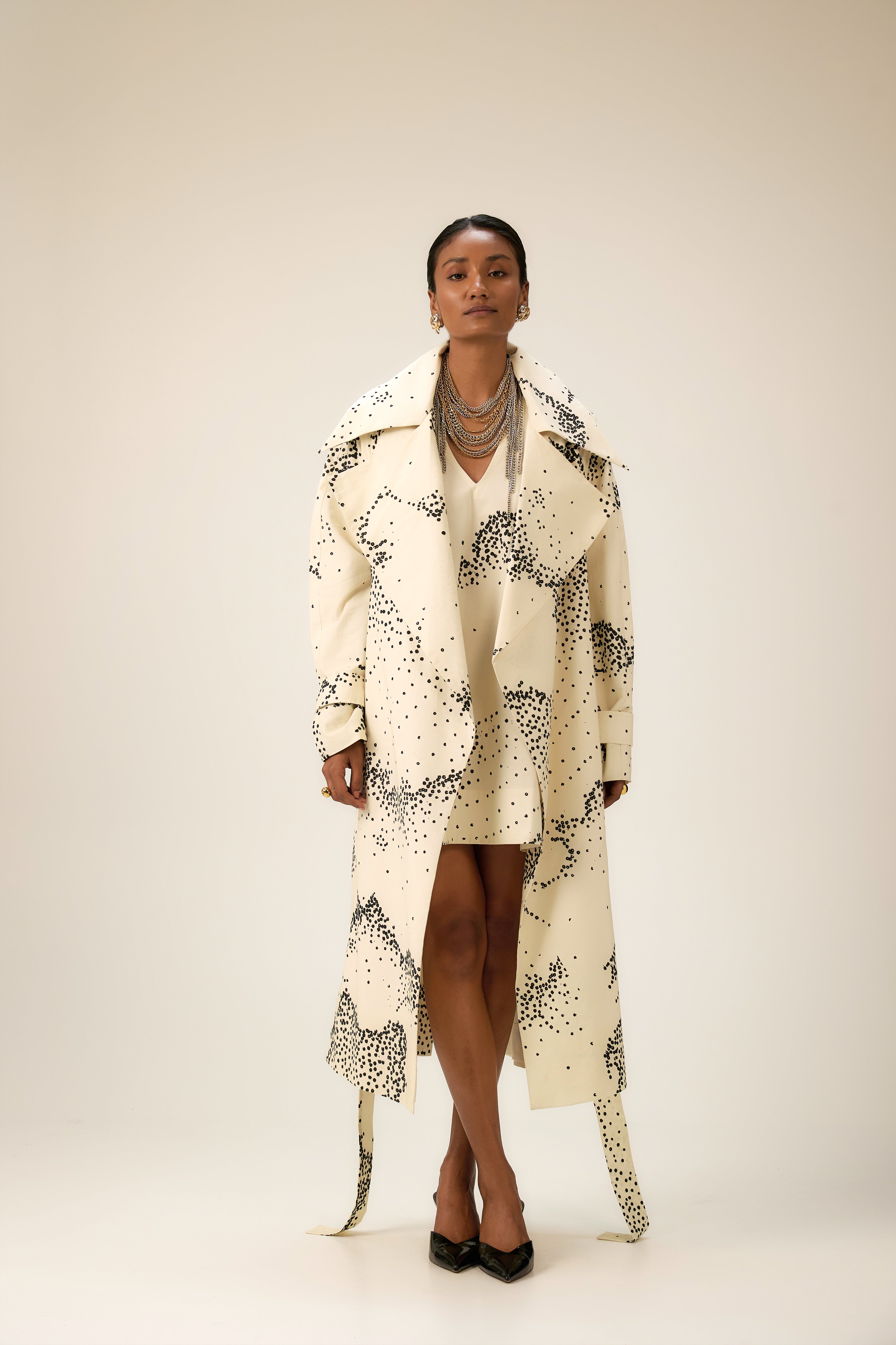 Artistic cotton ensemble blending fluid trench and structured dress