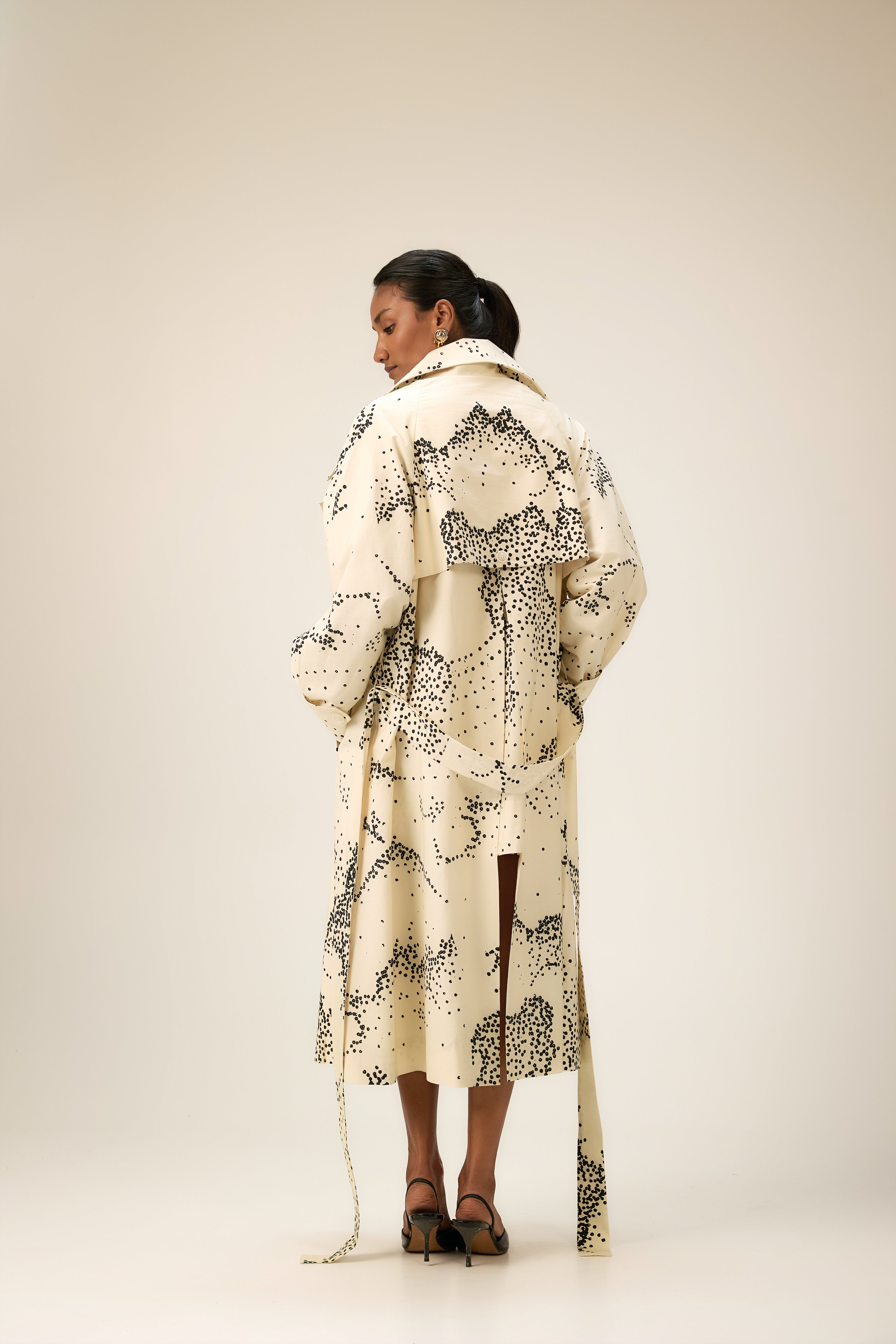 Model wearing XS trench and mini dress layered look