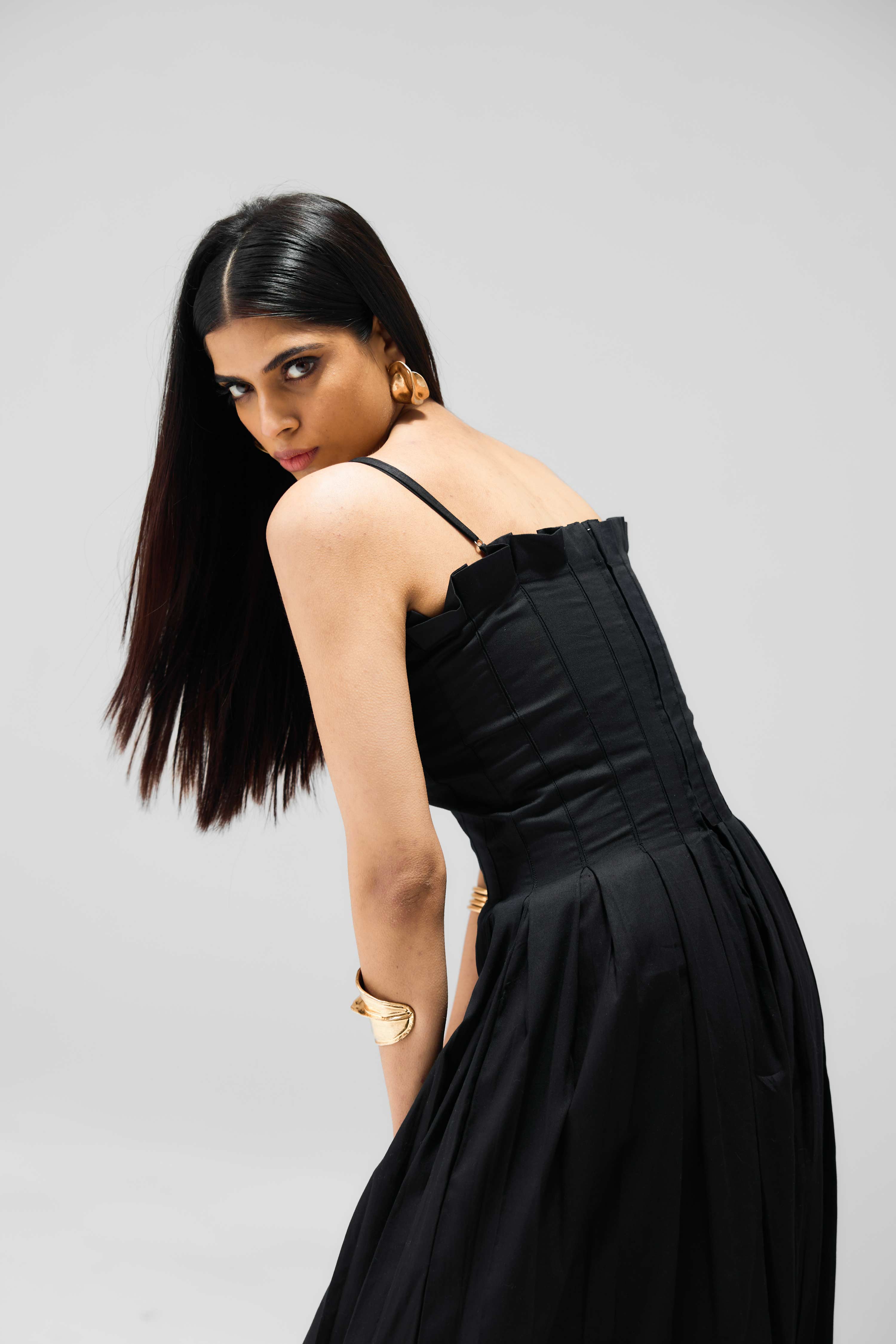 Full-length pleated dress with classic silhouette and modern appeal