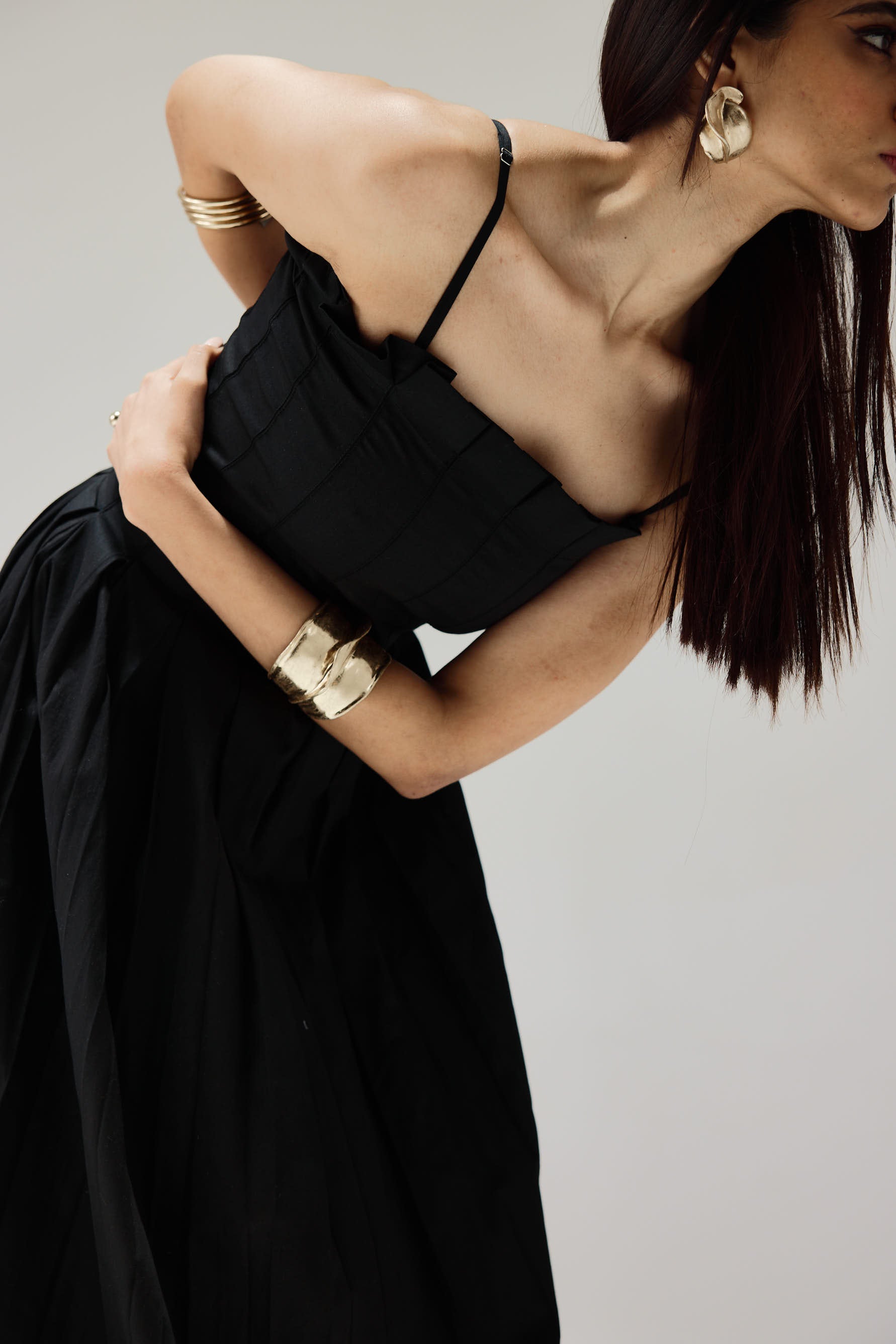 Elegant long dress featuring thin straps and full flowing silhouette