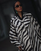 Front view of printed jacket and pants with fluid silhouette